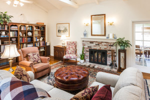 Living room with vaulted high beam ceiling and gas fireplace