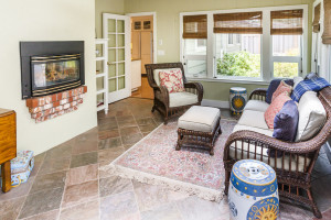 Family room with slate flooring, skylights, Casablanca fans, and lots of windows.