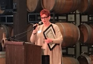 Judie Profeta, owner/broker of Alain Pinel Realtors, Carmel accepting Citizen of the Year Award