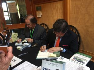 Authors signing their books for eager readers.